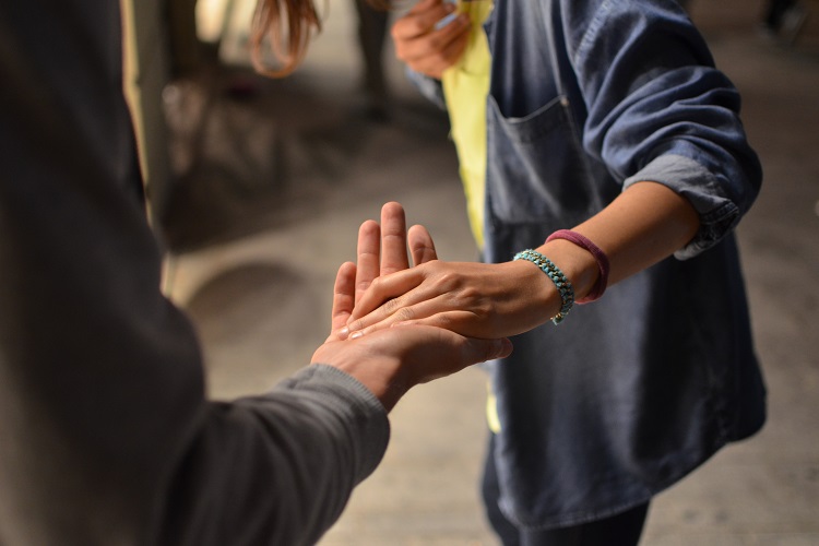  two people lightly holding each other's hand