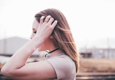 woman with hand touching her hair