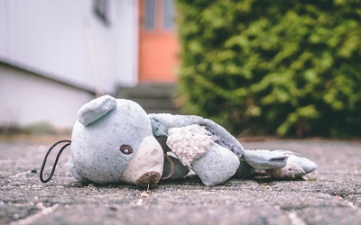 toy bear lying on the ground 